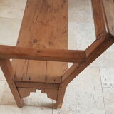 Church bench in fir tree with armrests
