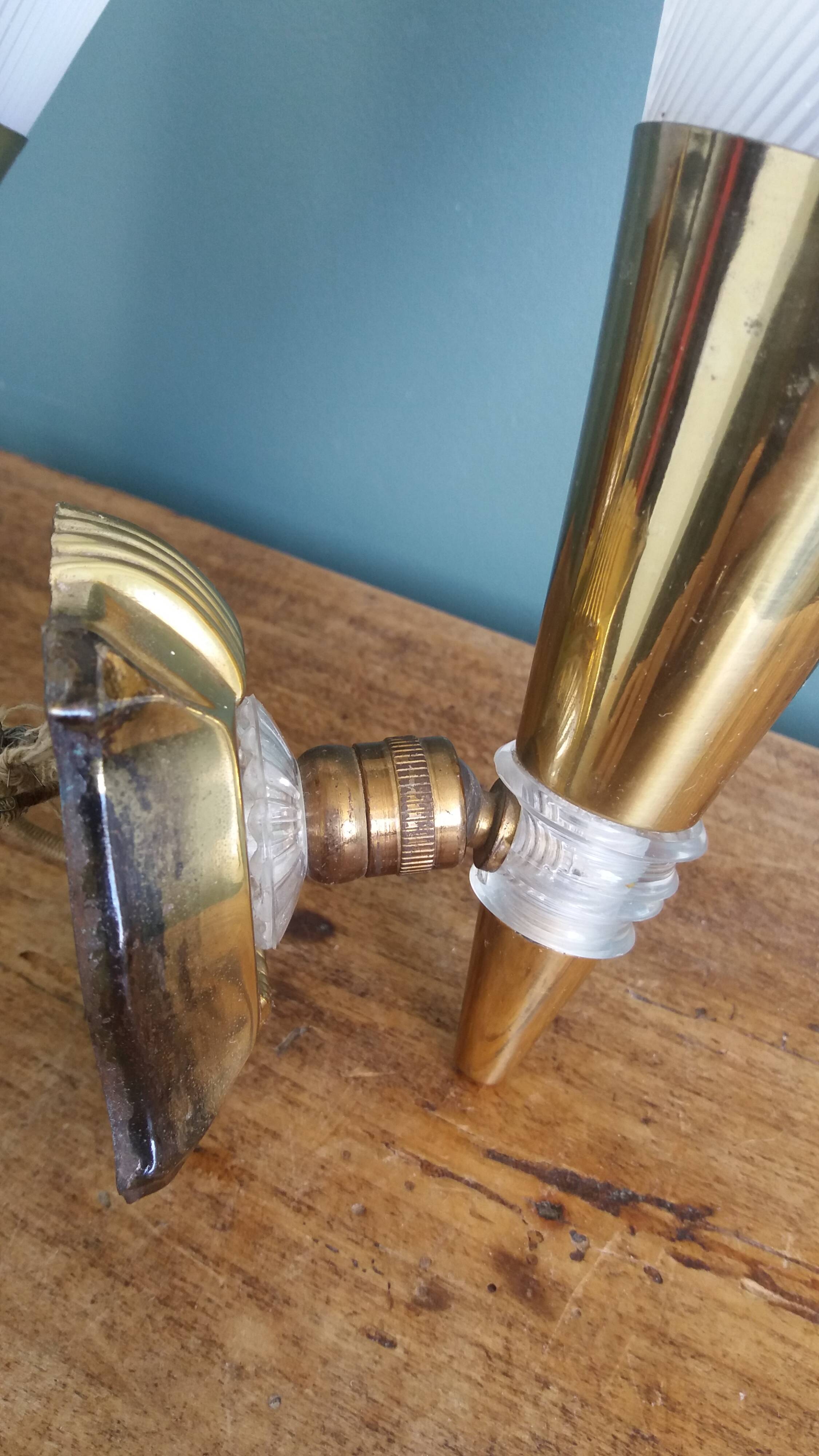 Brass and plexiglass wall lights in the Maison Lunel style.