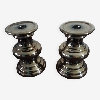 Two bronze-colored candlesticks