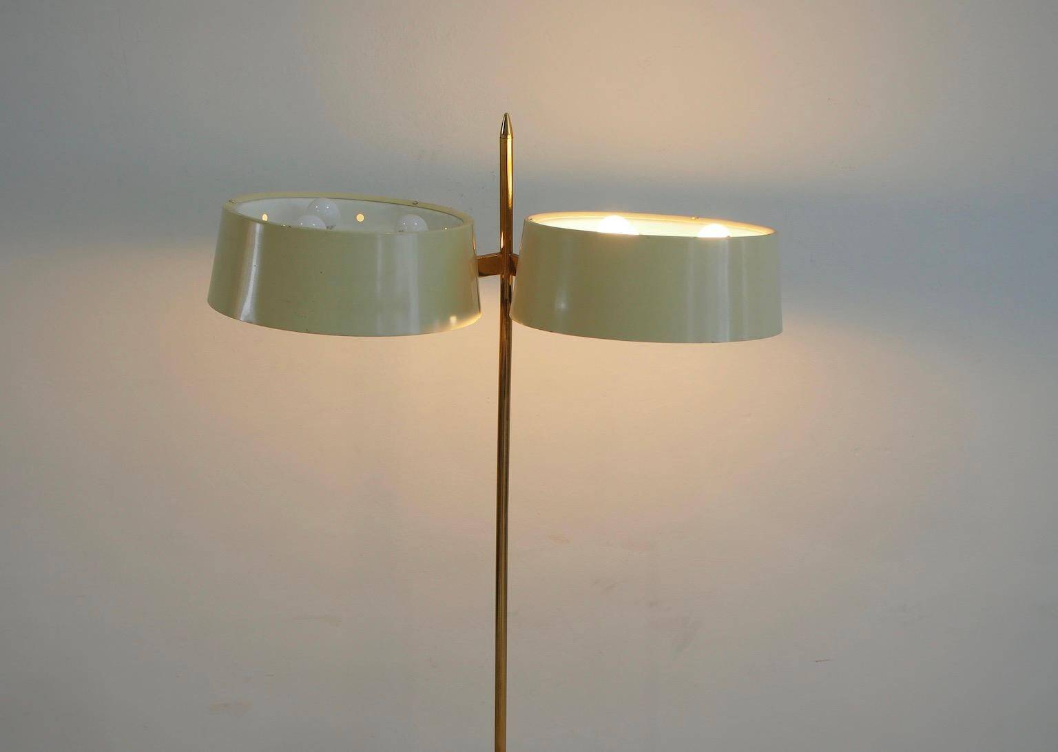 Brass and lacquered metal floor lamp with a wooden magazine shelf.