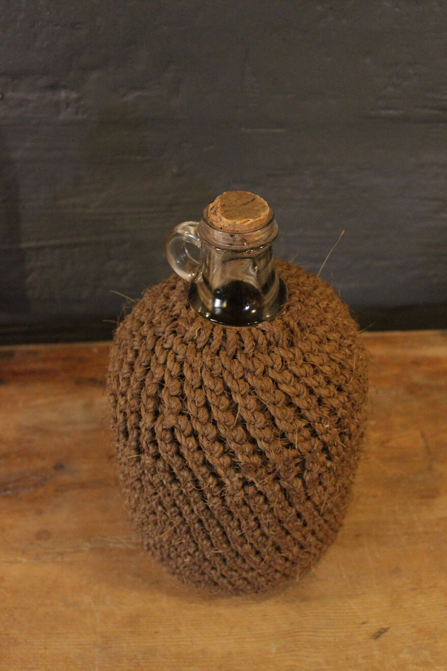 Cylinder glass surrounded by rope