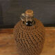 Cylinder glass surrounded by rope