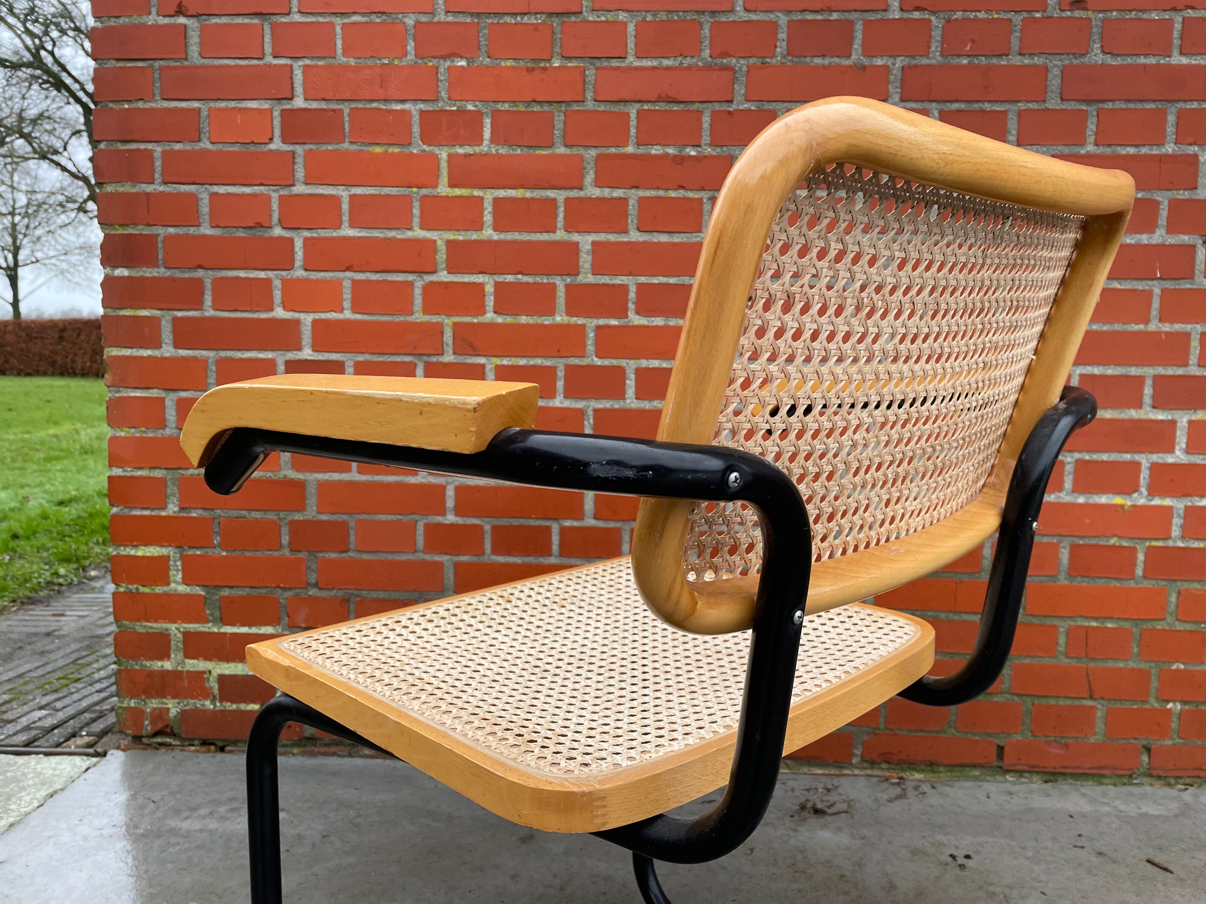 Cesca model chair designed by Marcel Breuer with black-framed armrests