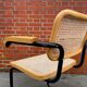Cesca model chair designed by Marcel Breuer with black-framed armrests