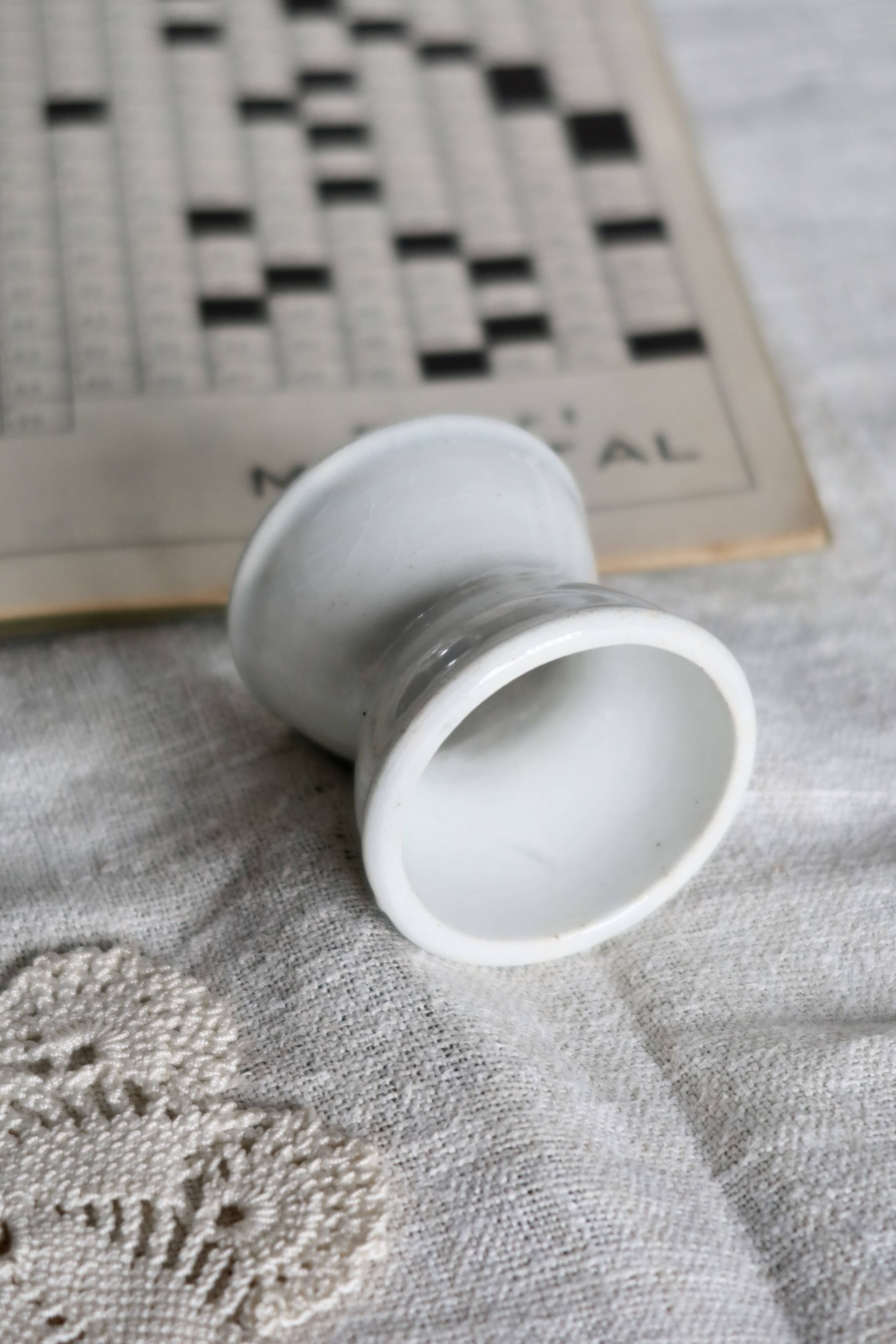 Antique diabolo egg cup in white earthenware