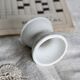 Antique diabolo egg cup in white earthenware