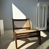 Reclined armchair in canned teak in natural wood
