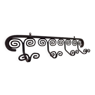 Vintage wall coat rack in solid wrought iron.