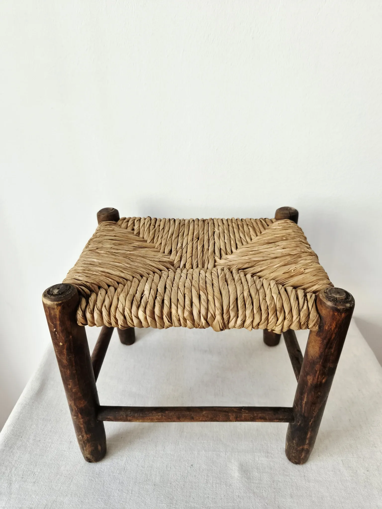 Small rustic vintage wooden and straw stool -
