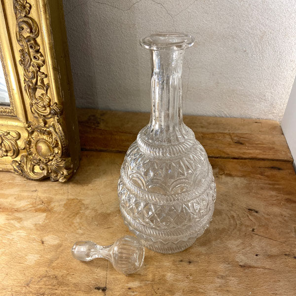 Large blown glass decanter and relief decoration