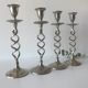 Four twisted silver candlesticks