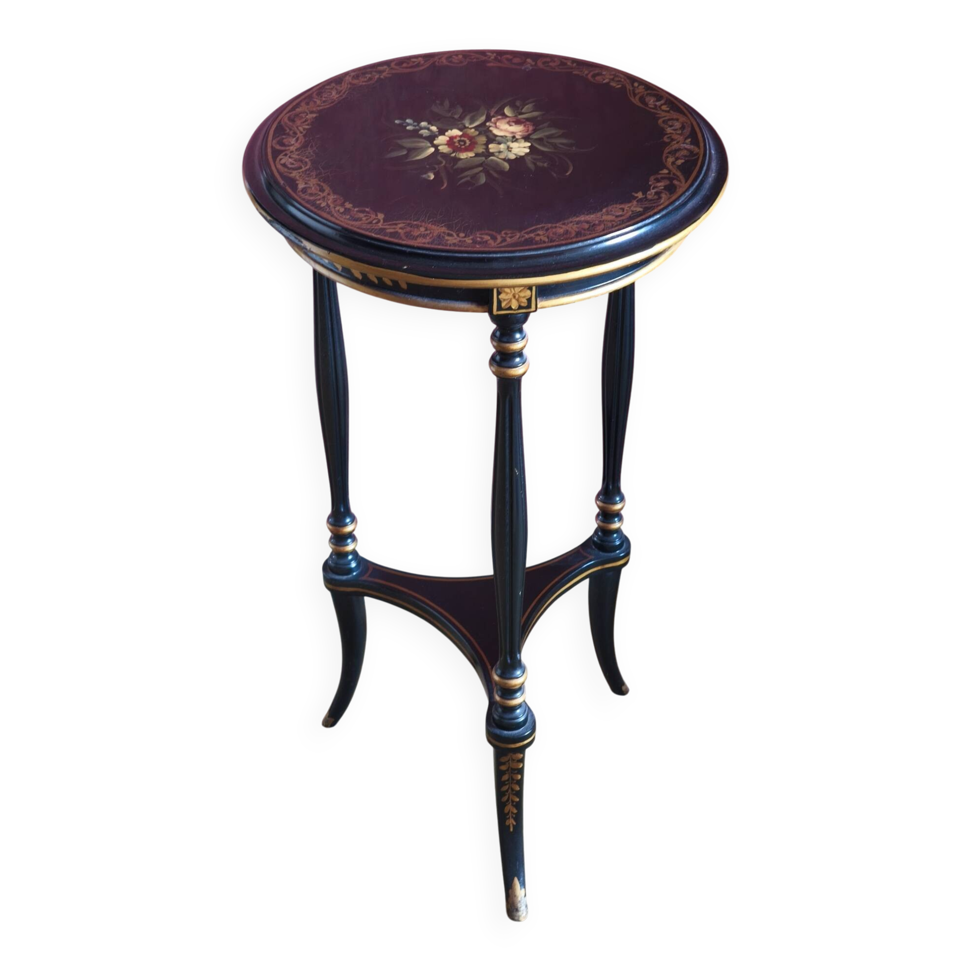 Tripod stool in blackened wood with painted floral decoration.