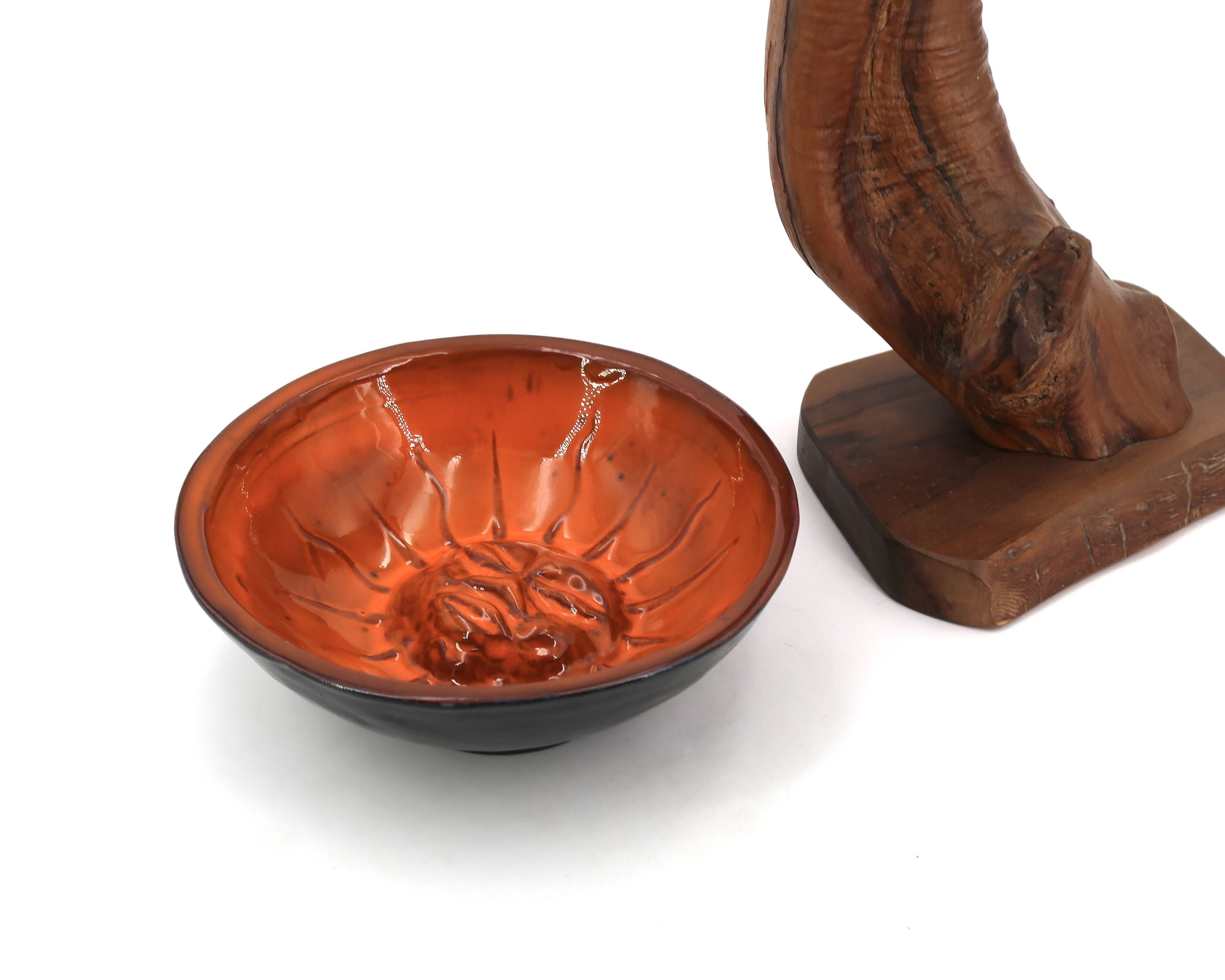 Mexican ceramic catchall in orange and black, 1970s sun face.