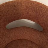 Circular armchair trimmed with orange fabric