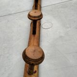 Old rustic wooden coat rack turned in imitation of bamboo