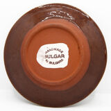 Bulgarian artisanal plate with autumn-hued flower