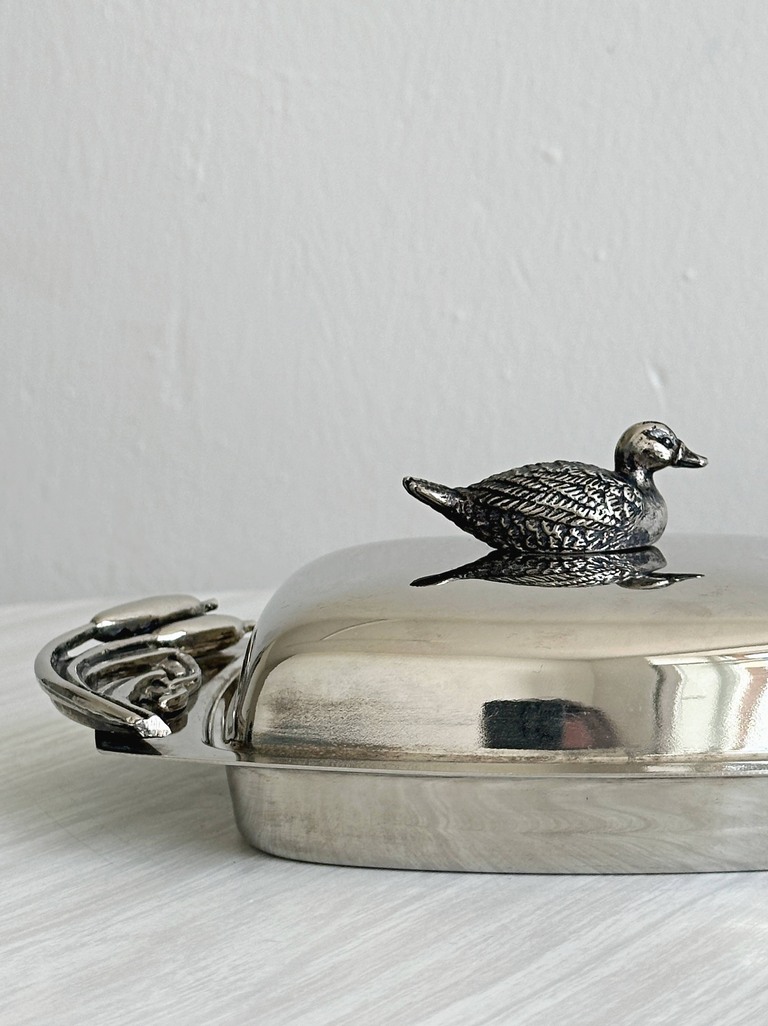 Antique shiny metal butter dish