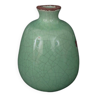 20th century cracked ceramic vase with green background