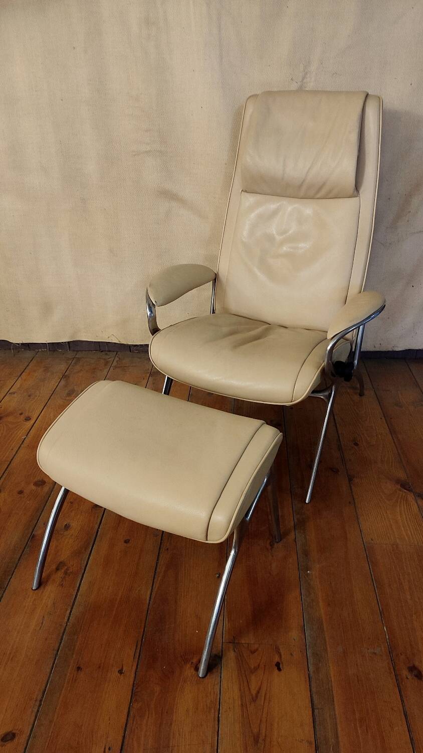 Beige leather armchair and footstool