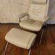 Beige leather armchair and footstool
