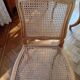 Carved wooden dining table and its 5 rattan caned chairs.