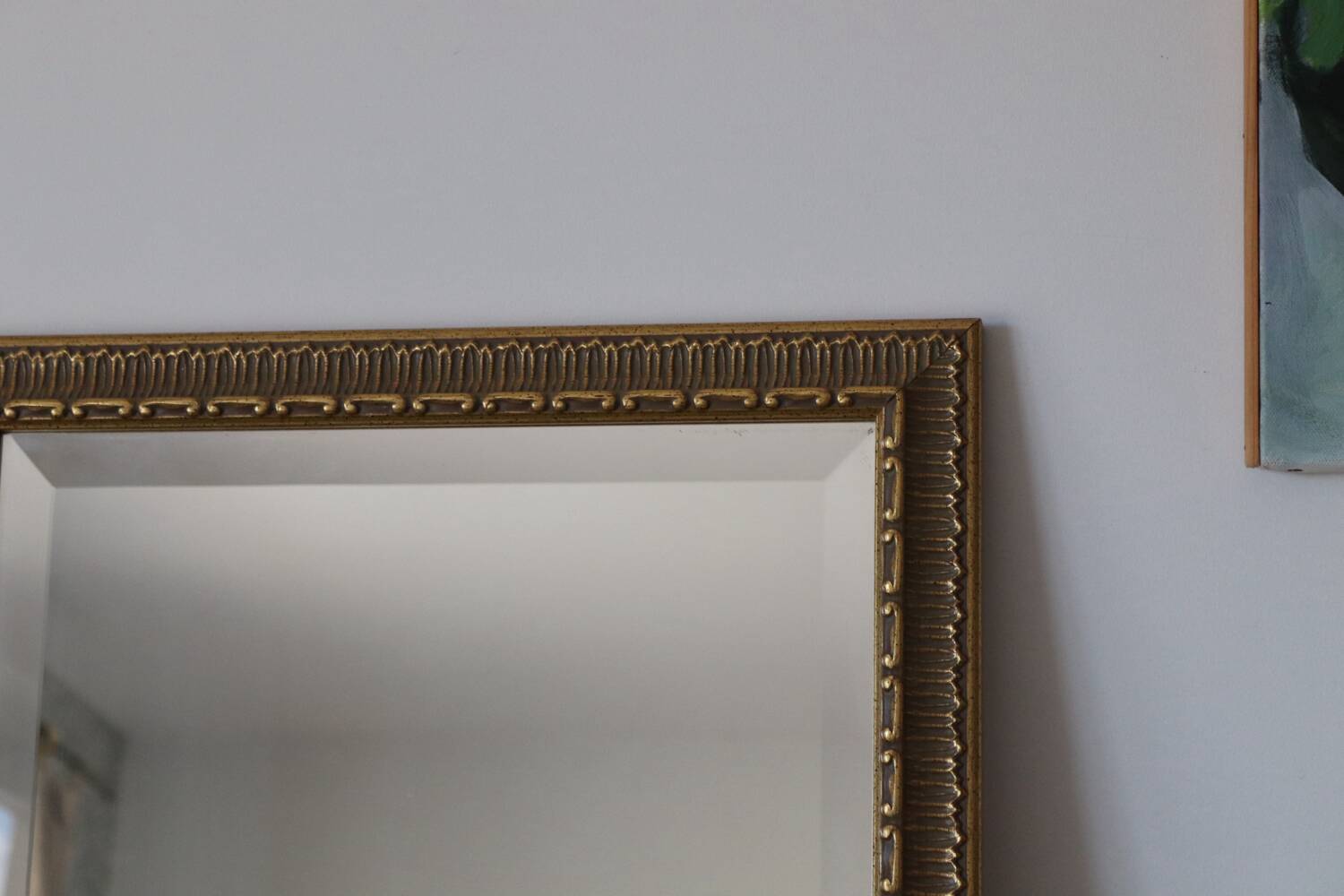 Rectangular gold mirror with moulded decoration.