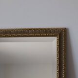 Rectangular gold mirror with moulded decoration.