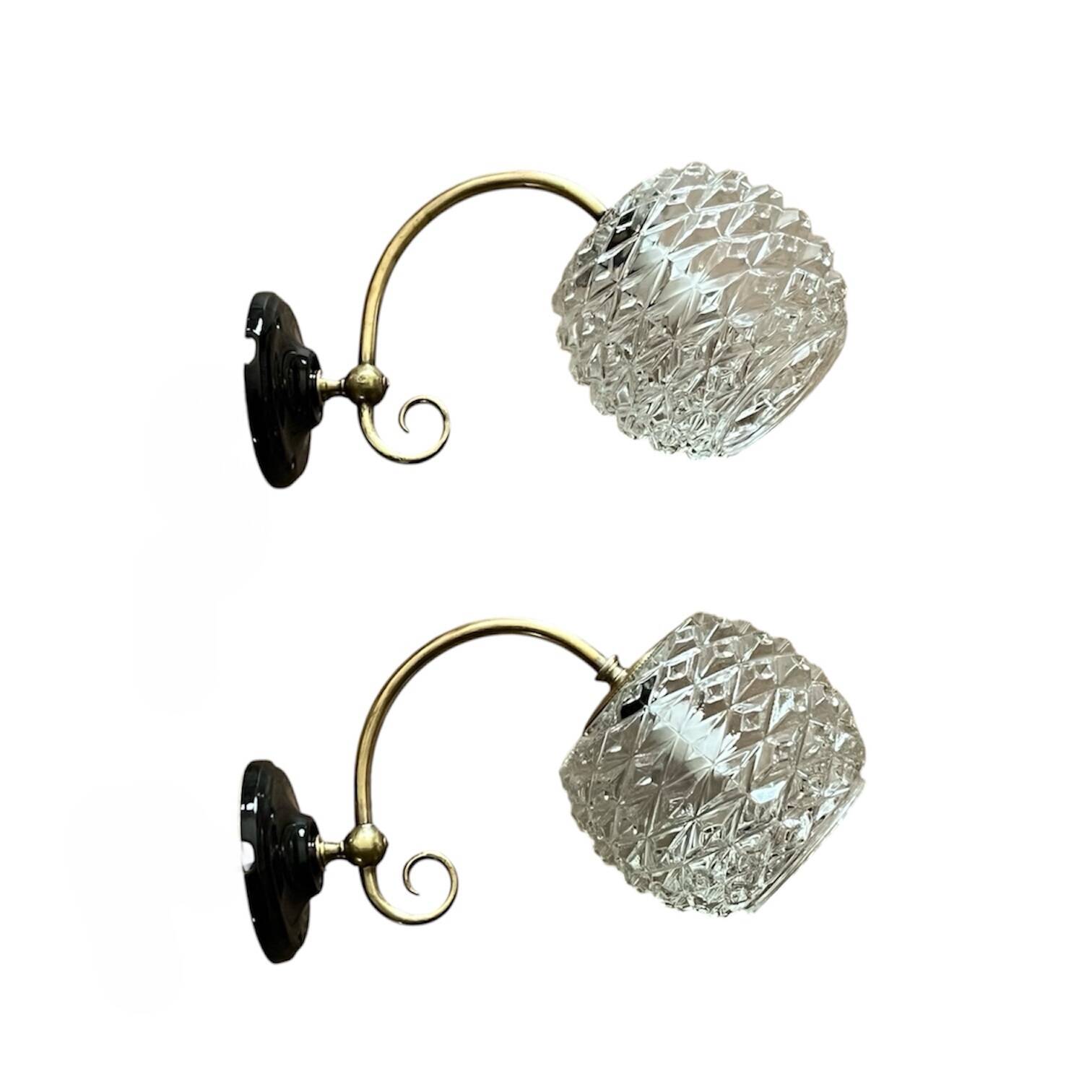 Pair of antique wall sconces with swan necks and glass globes.