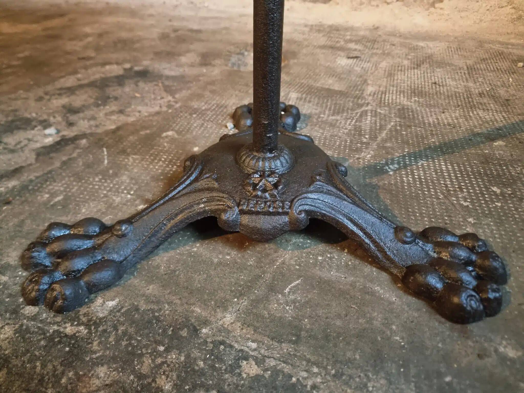 Old French bistro table with a marble top and a cast iron base.