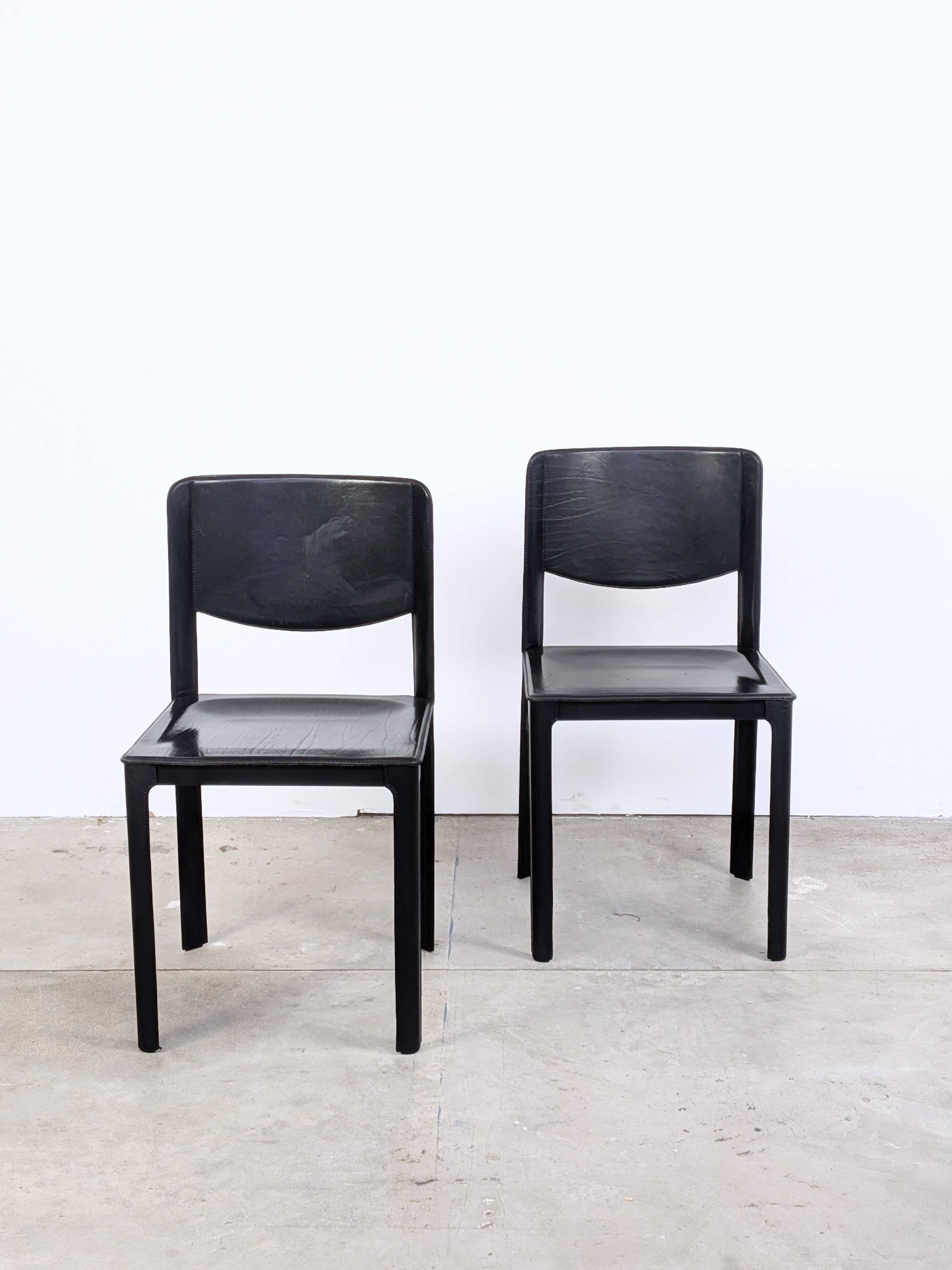 Pair of Matteo Grassi chairs in black saddle leather, 1980s.