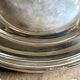 Round, hollow silver-plated metal dish