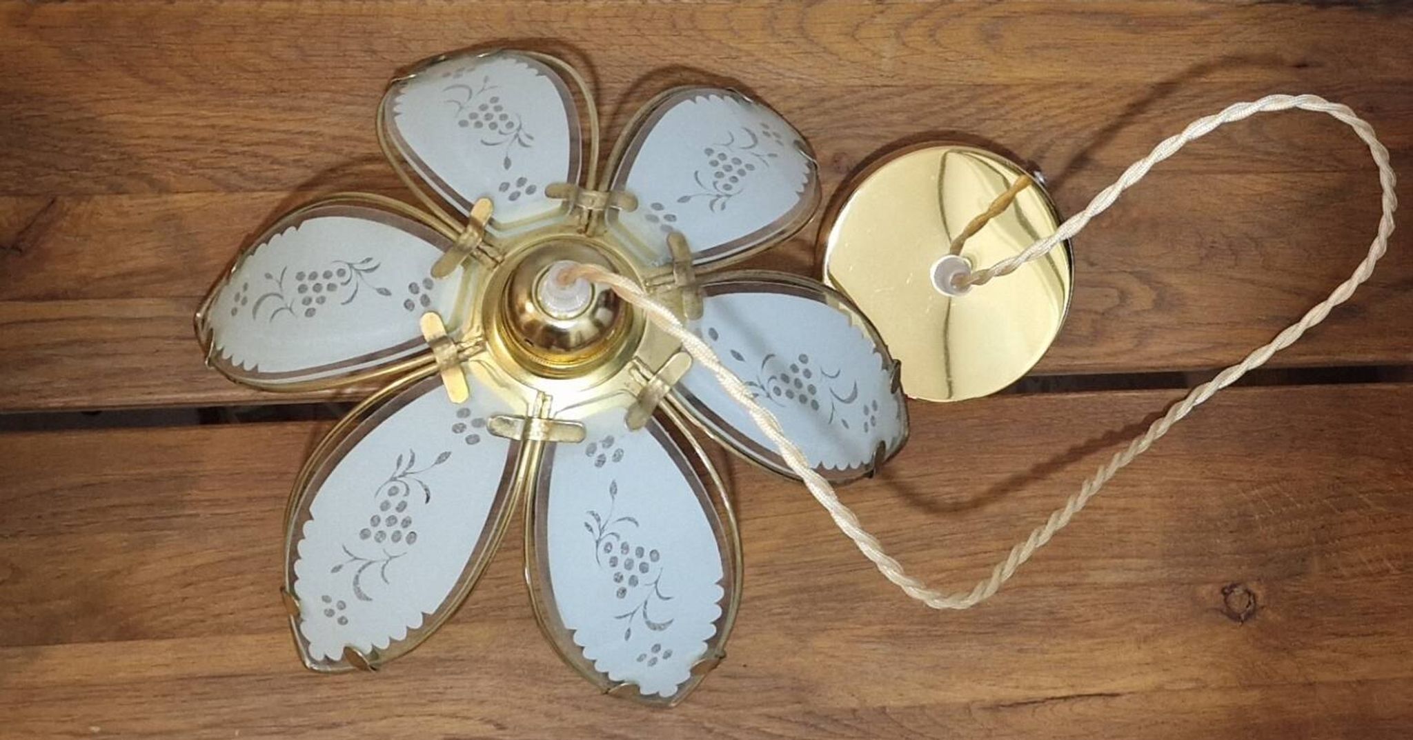 Glass flower rimmed with brass