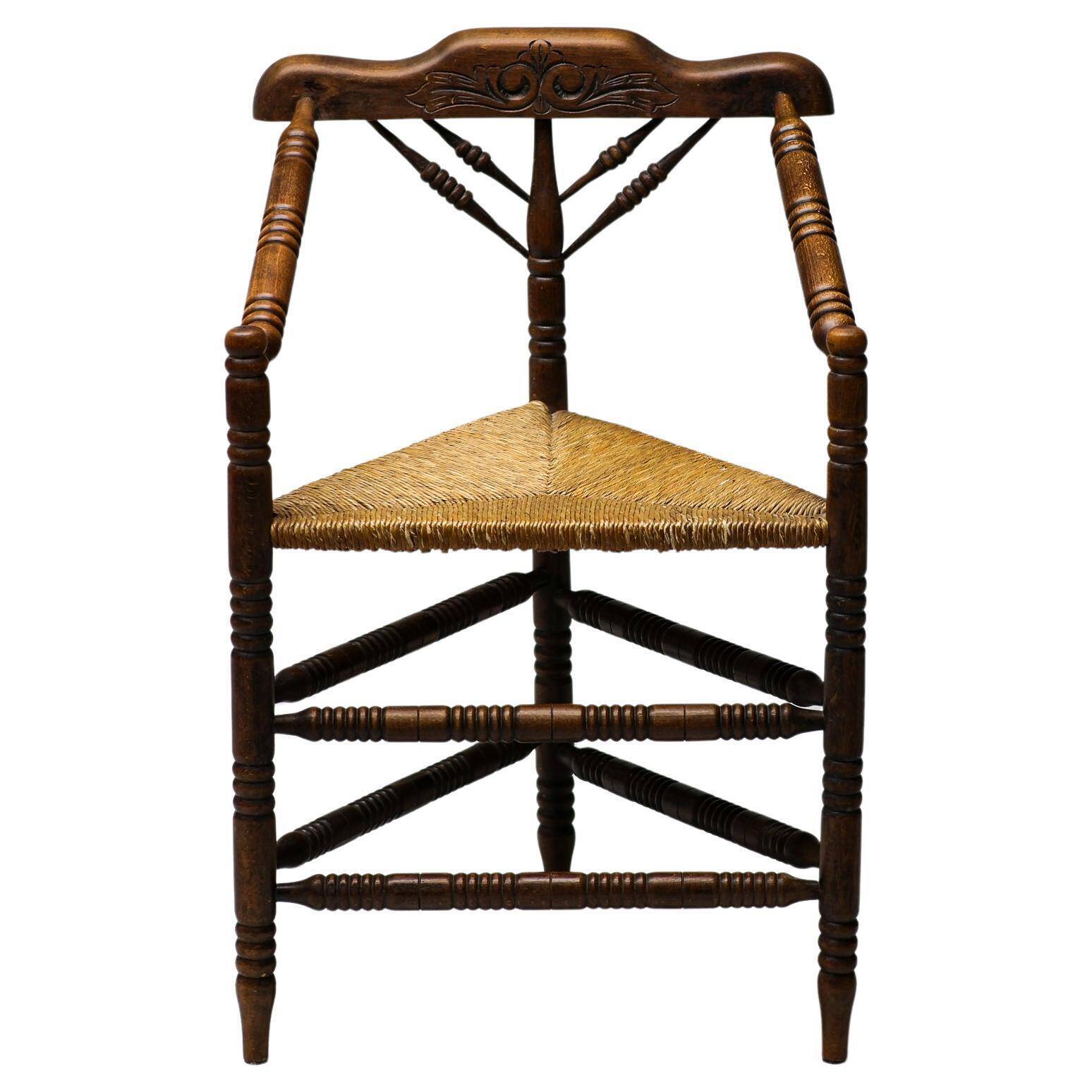 Mid Century Antiques spindle wood chaise with a rush seat.