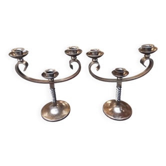 Pair of wrought iron candlesticks signed Charles Piguet