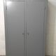 Curved wardrobe workshop locker made of wood repainted in grey.