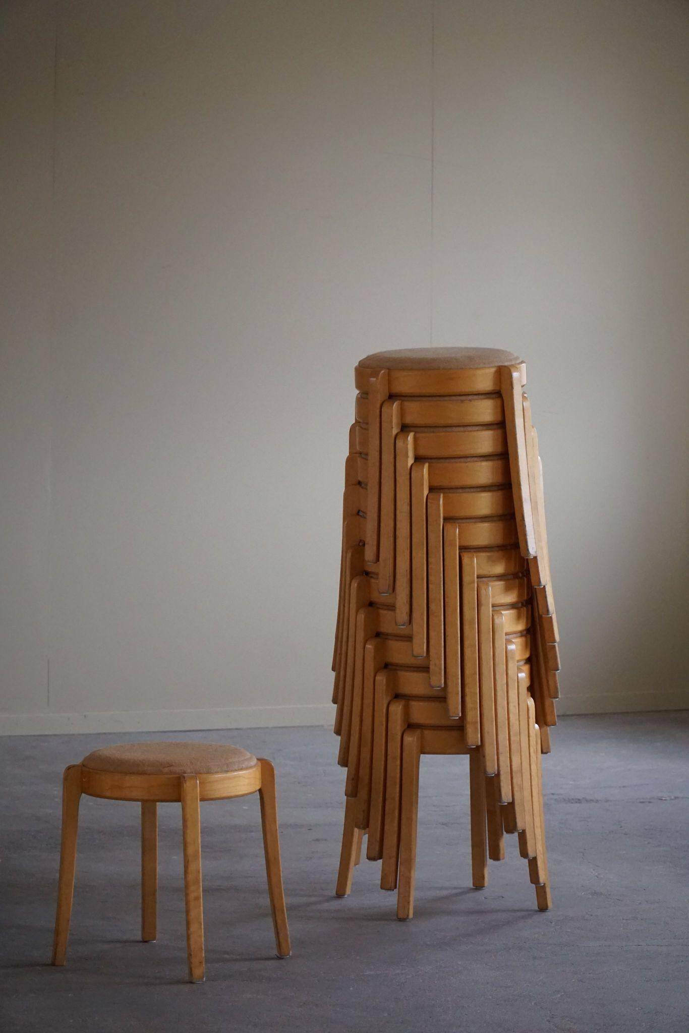 Modern Swedish, set of 14 stackable stools in birch and hessian fabric, 1980s.