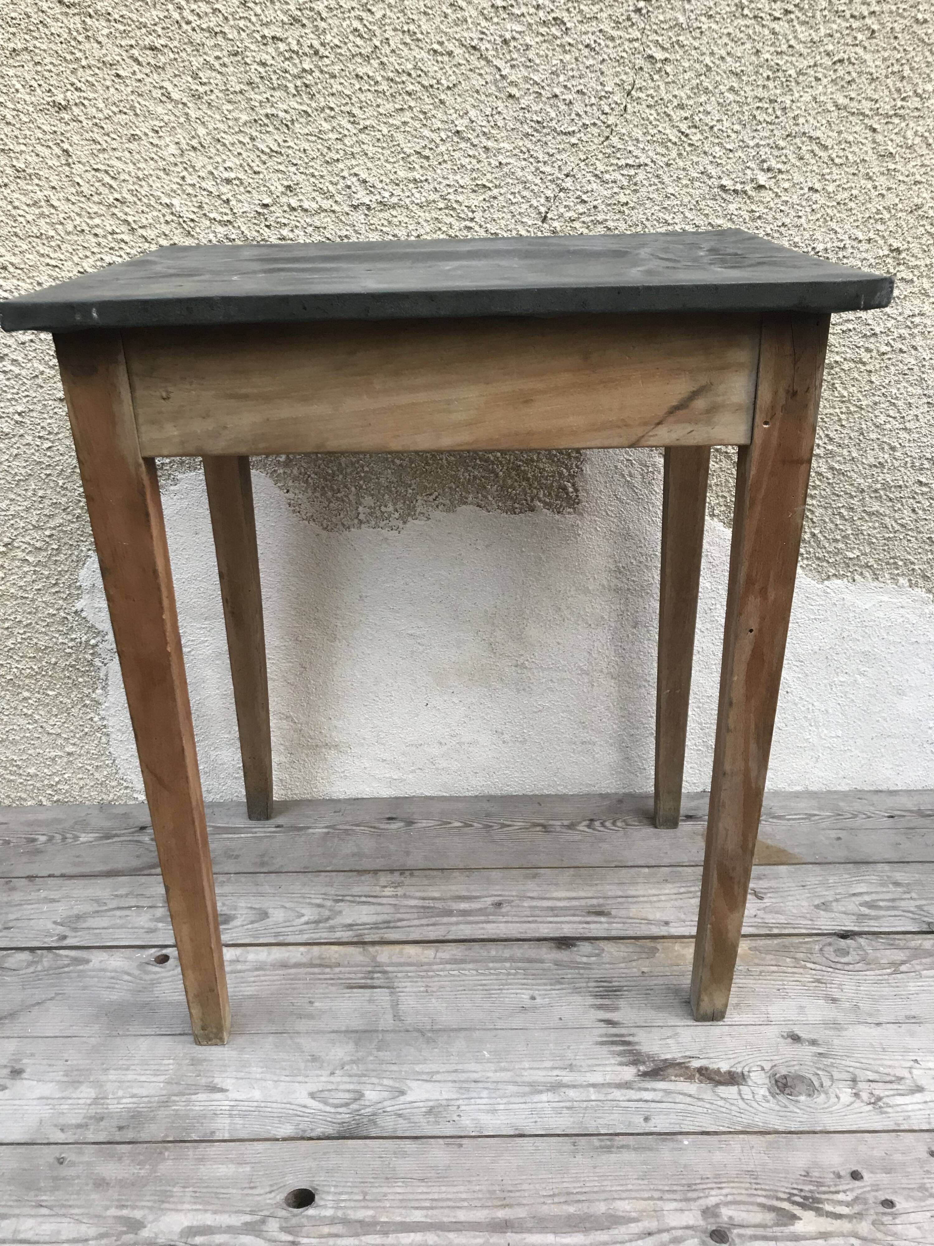 Old kitchen table in wood with compass feet