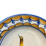 Earthenware plate representing a bird signed Lario
