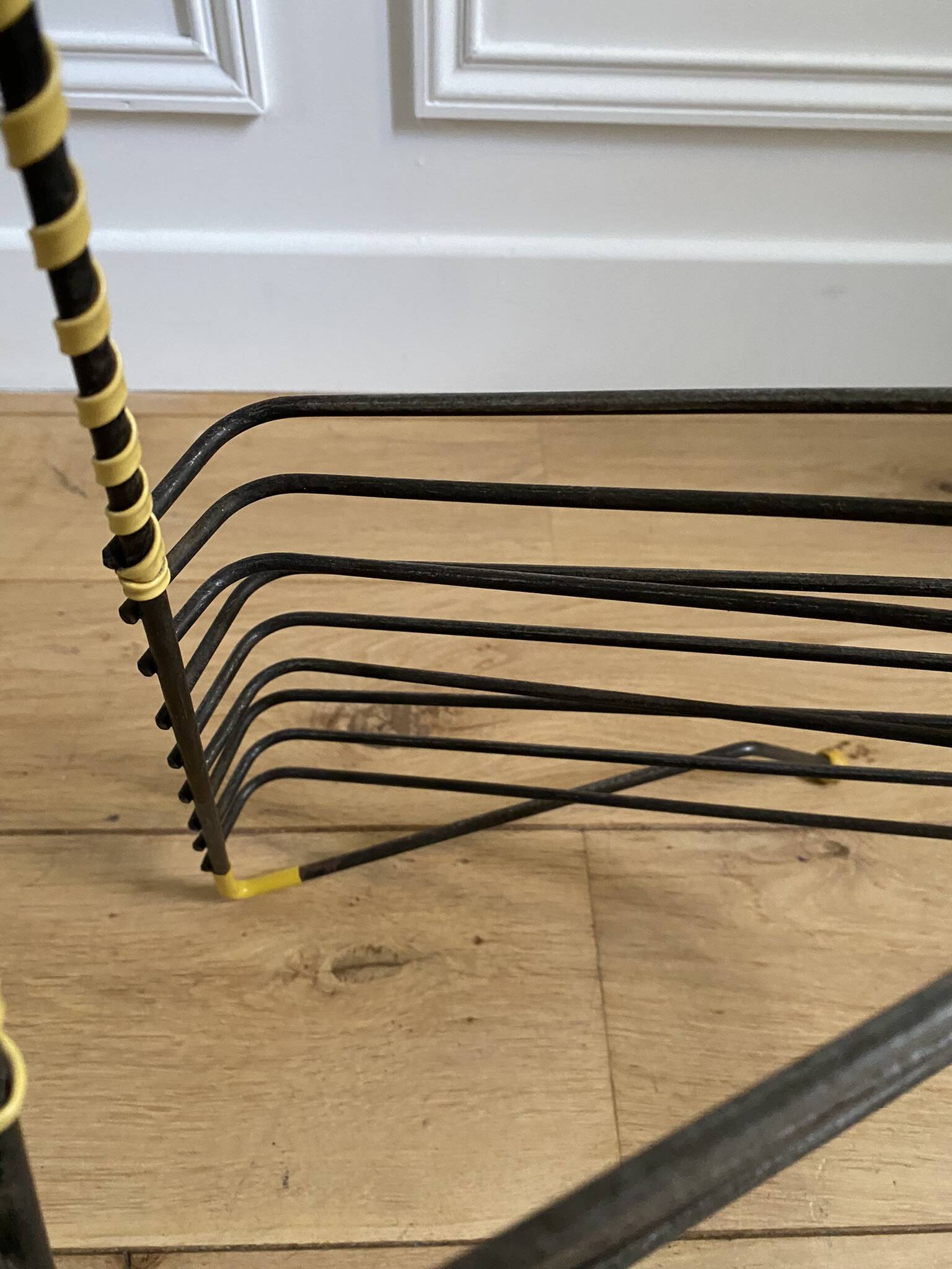 Black metal vinyl record holder and yellow scoubidou from the 60s
