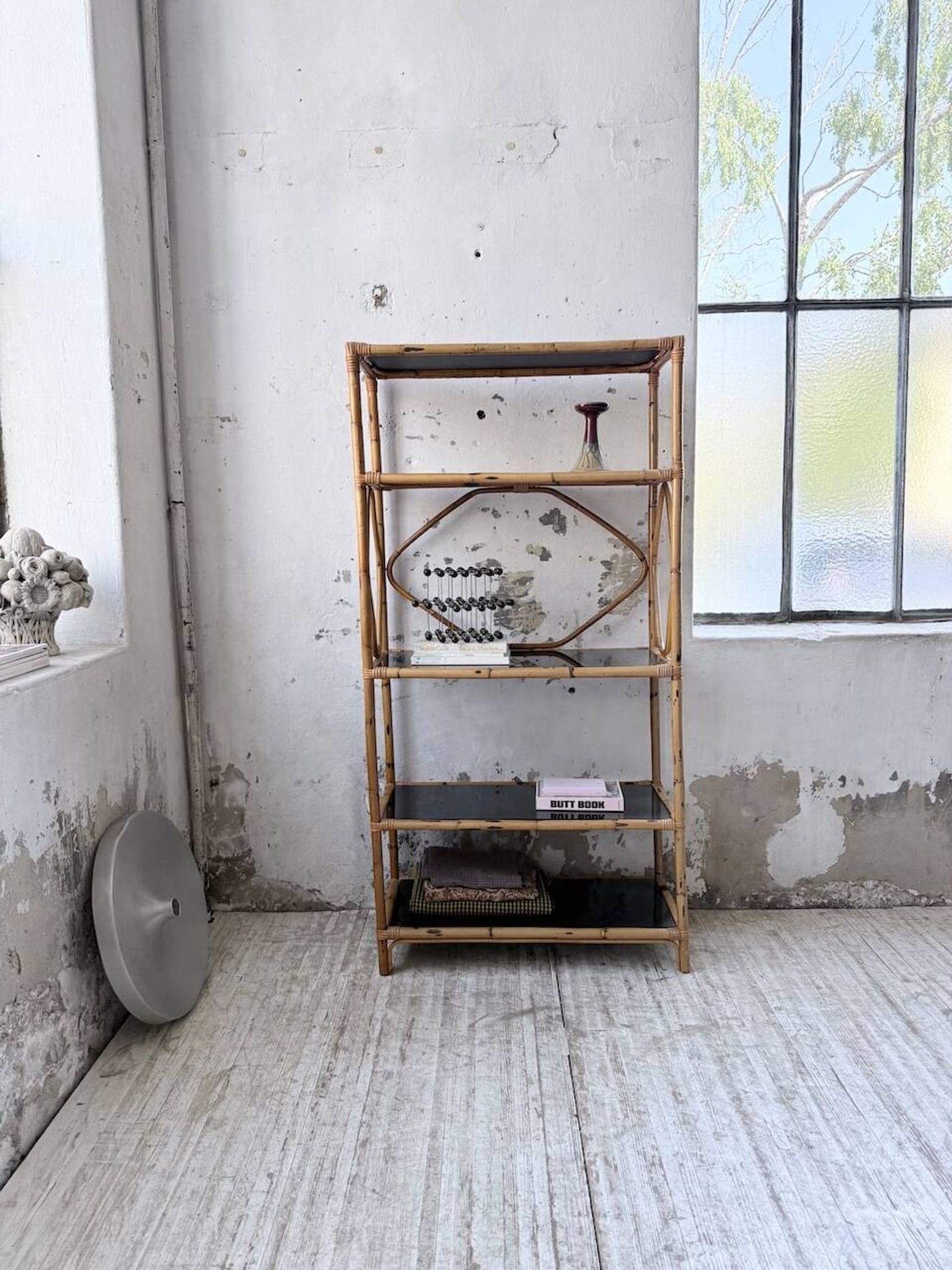 Rattan bookshelf and black glasses