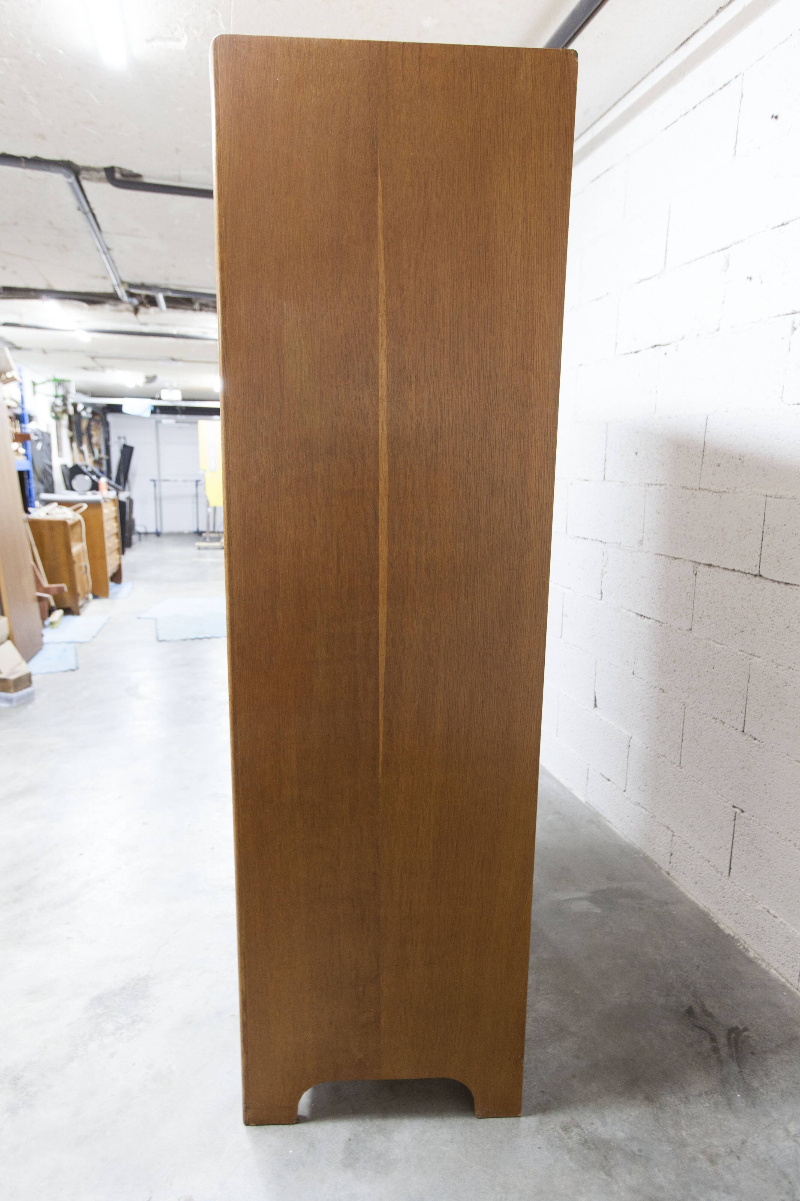 1950s Mid-Century Modern oak armoire with two doors and two drawers.