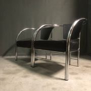 A pair of petite low armchairs by ronald cecil sportes for lumen center, 1987