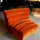 Burnt orange modular sofa for four with a futuristic design.