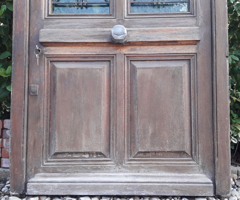 Oak entrance door and its frame and transom, wrought iron gates