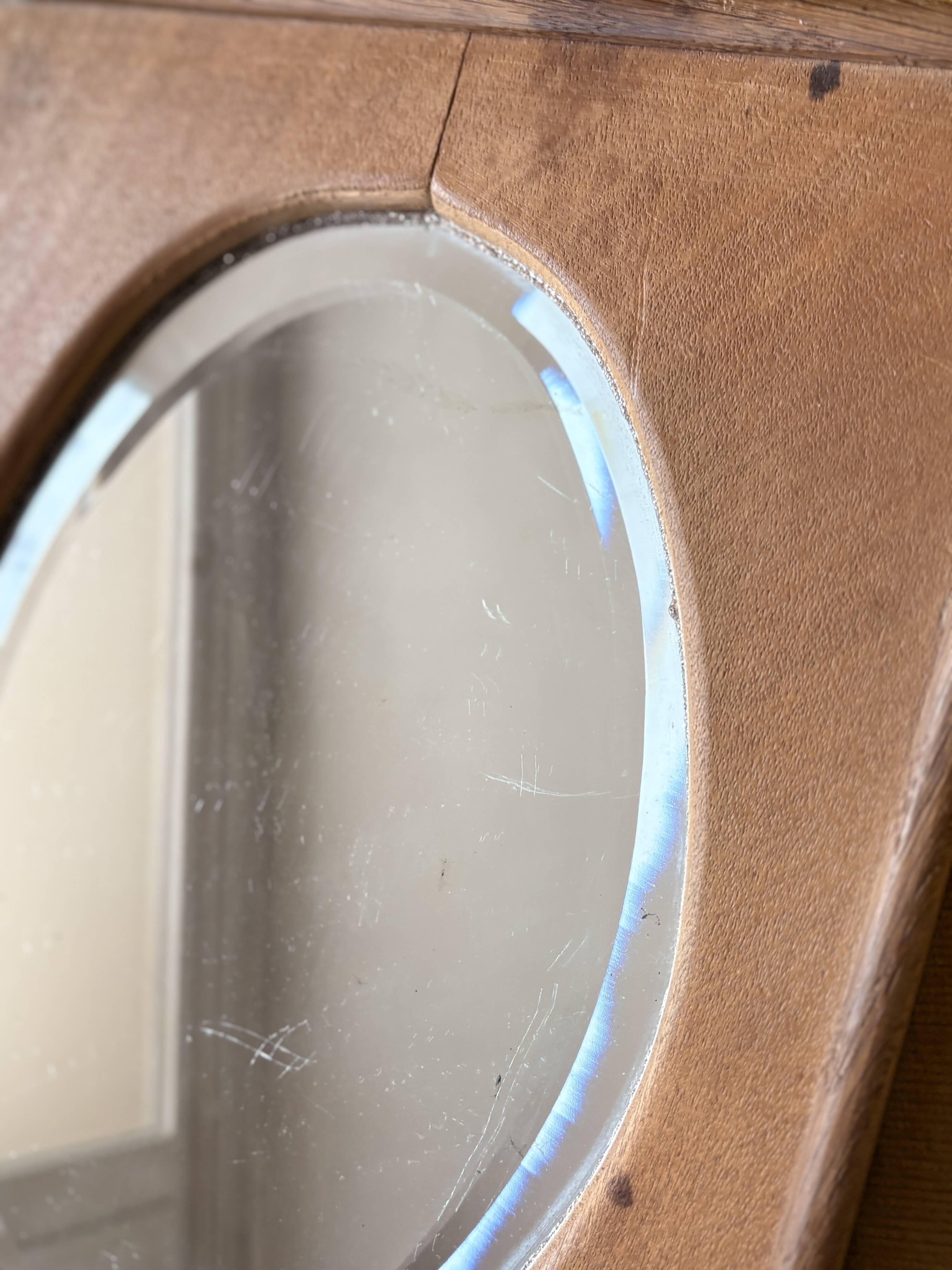 Bevelled oval mirror on oak frame