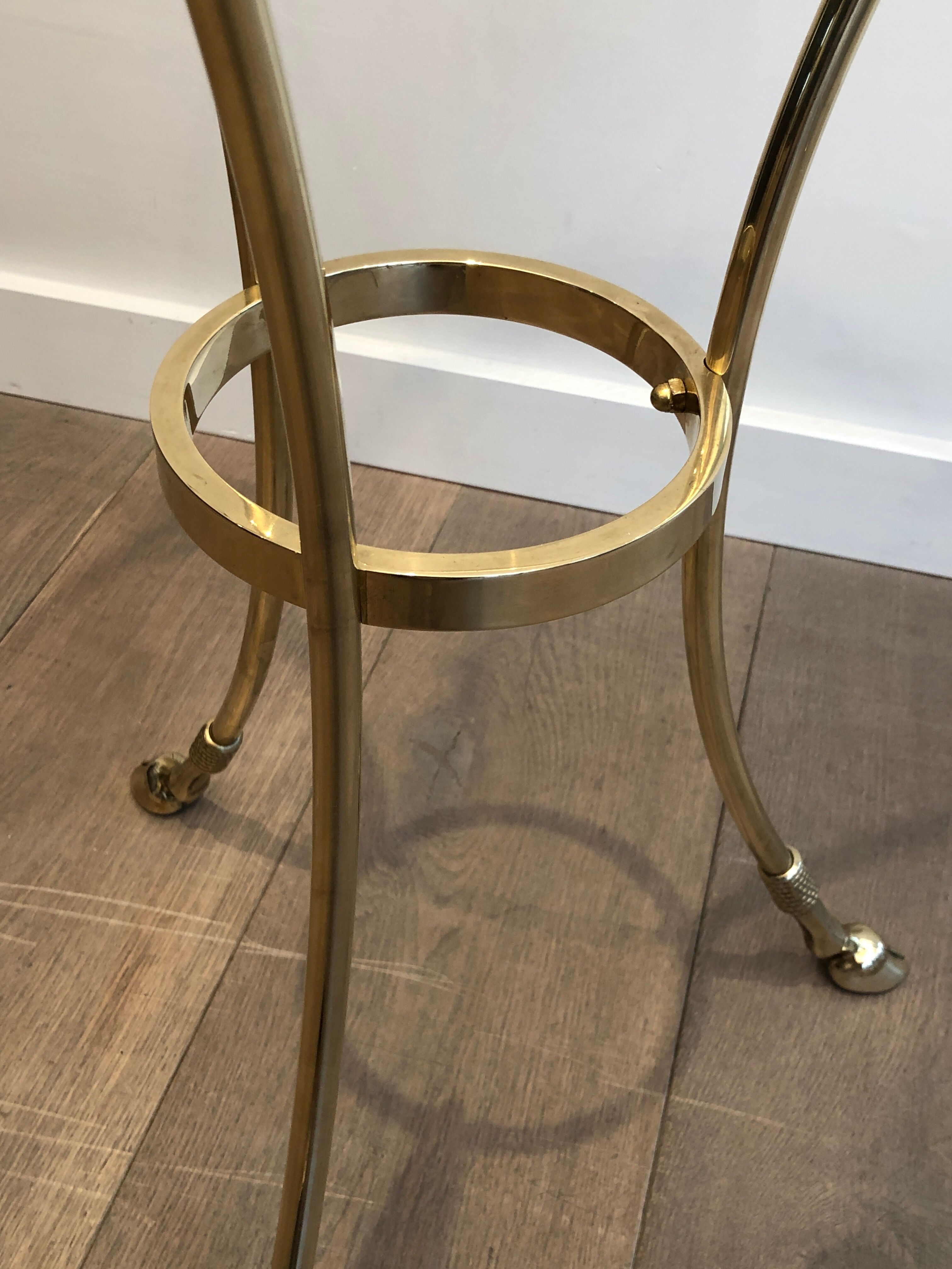 Neoclassical style tripod pedestal table in brass and round glass top in the taste of the House