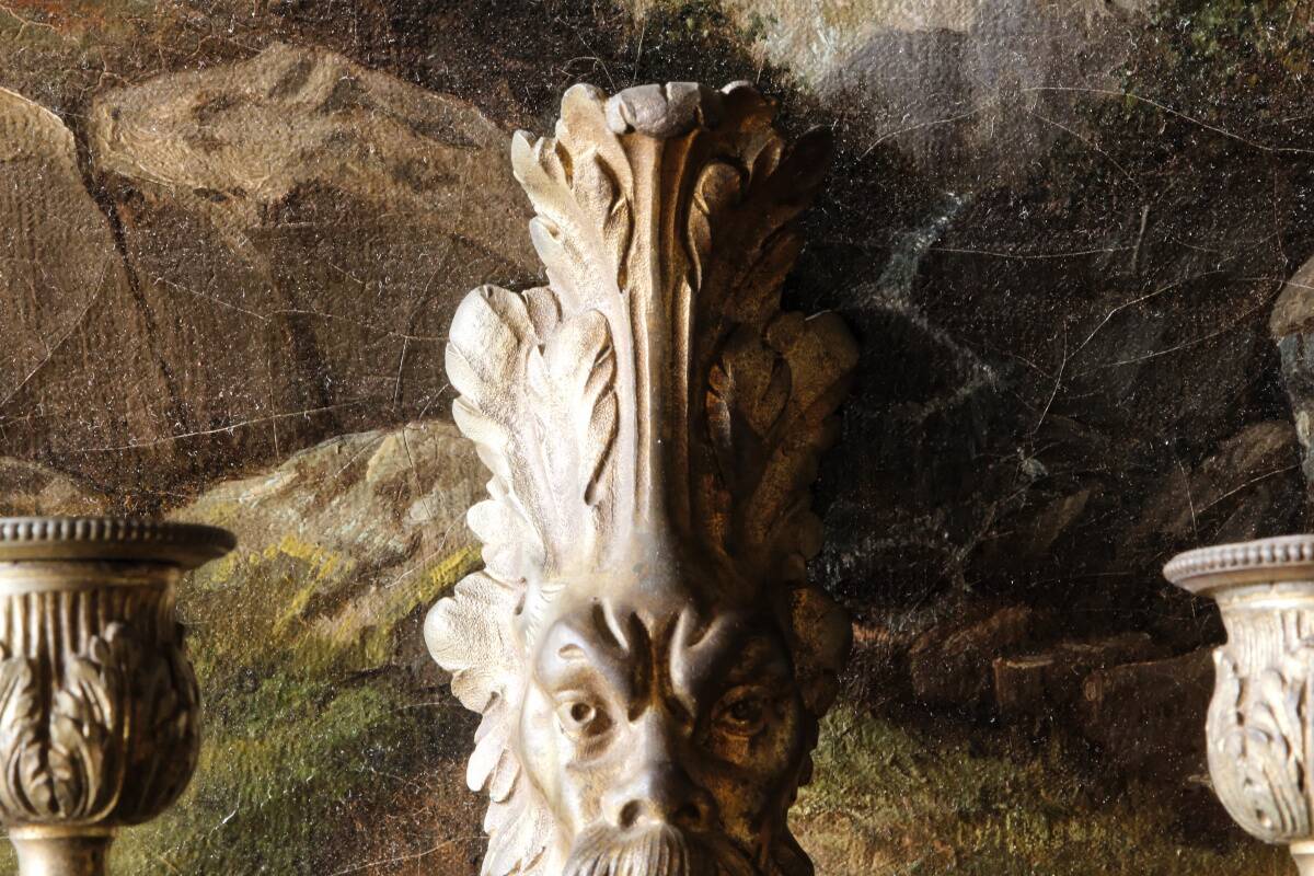 Monobloc gilded bronze wall light, grotesque satyr, two lights.