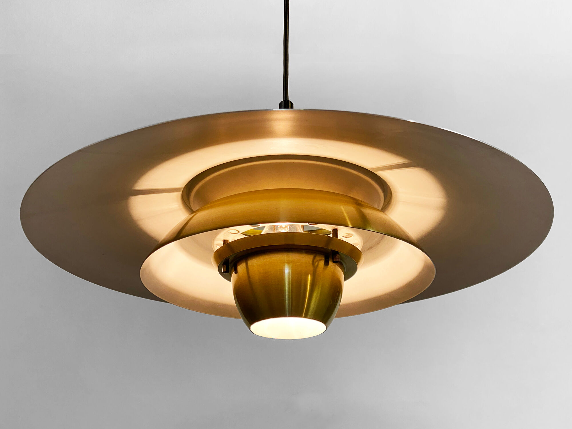 Large brushed aluminum pendant light with golden finish. Produced by Jeka. Denmark 1970s
