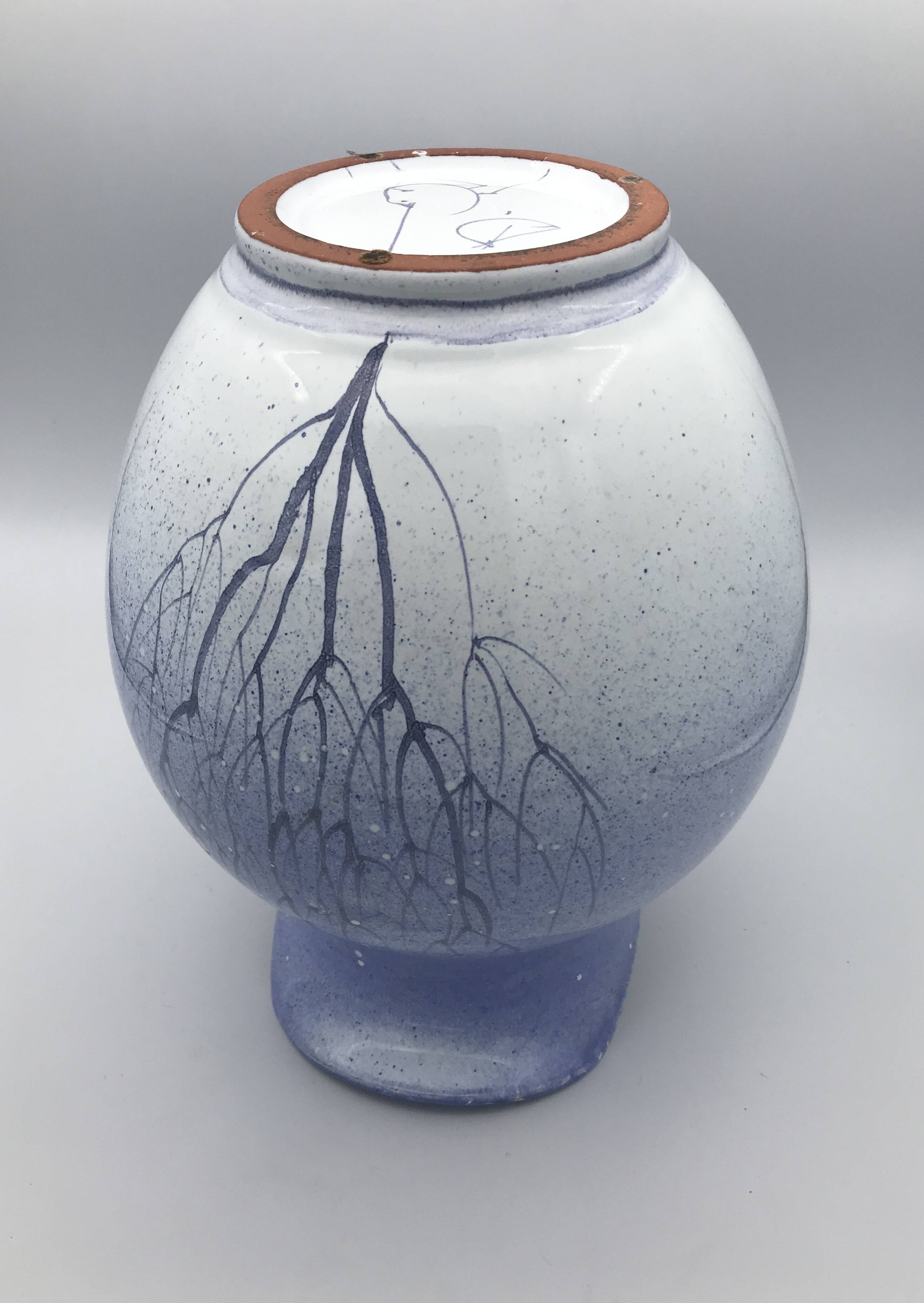 Blue glazed terracotta pitcher with hand-painted decoration, signed