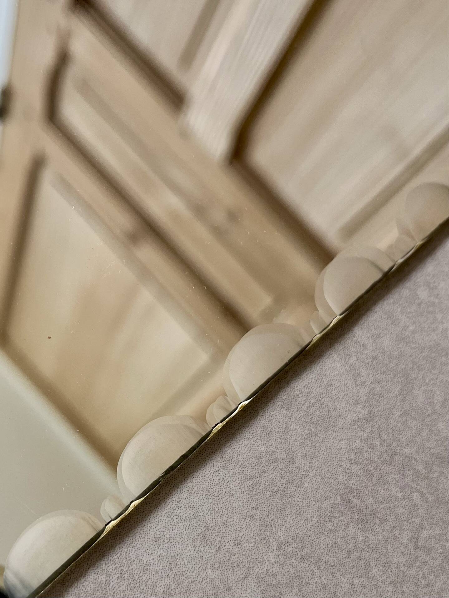 Small bevelled wall mirror from the 1940s.